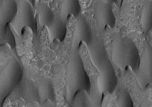 Sand dunes sculpted by wind on Mars. Yes, there is wind on Mars although the atmosphere is very thin so the size of particles that can be lifted in the air is less than on Earth.