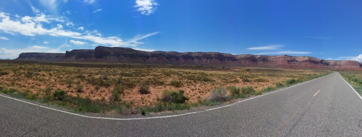 A panorama image taken with my phone of route 261 heading north of the Goosenecks of the San Juan River.  In the distance is the plateau which we would need to climb to get to Muley Point which is on the left end.  Photo credit: Joel Duff