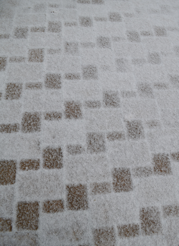 Differences in the types of patio stones (bricks) are seen in how quickly the snow melts when it lands on them.  Photo: Joel Duff