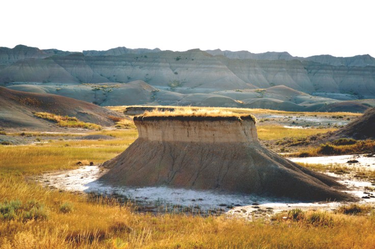 Grassy flat topped noll in Badlands National Park, SD.