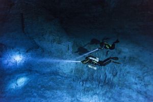 Divers search the walls of Hoyo Negro, the underwater cave on Mexico's Yucatán Peninsula where the ancient skeleton was found. PHOTOGRAPH BY PAUL NICKLEN, NATIONAL GEOGRAPHIC