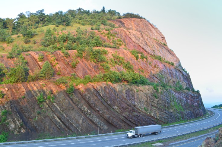 Sunrise hits the southside rocks of the Sideling Hill road cut along I-68.  I took this picture with the truck for scale. Image: Joel Duff