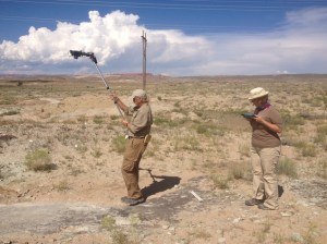In this undated photo provided by the Bureau of Land Management, Brent Breithaupt, a BLM paleontologist, left, and Neffra Matthews, a BLM photogrammetry specialist, photograph the dinosaur track site for 3-D documentation north of Moab, Utah. A dry wash full of 112-million-year-old dinosaur tracks are set to be opened to the public this fall near Moab. (AP Photo/The Bureau of Land Management)