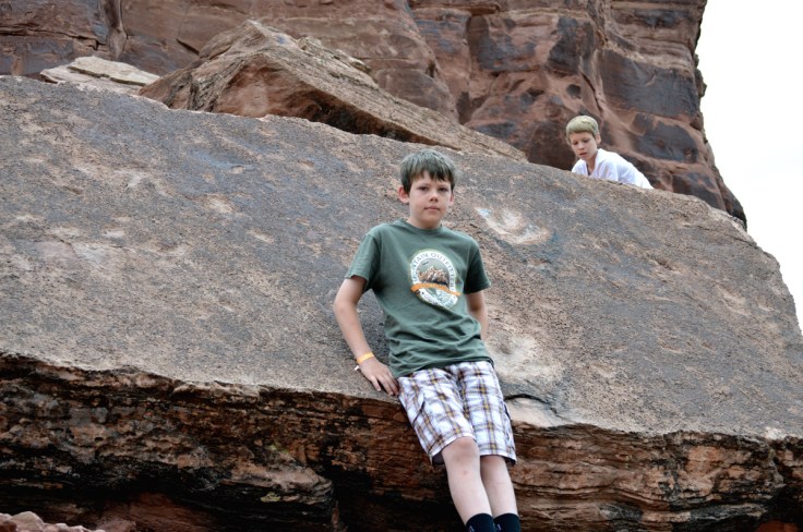 Dinosaur footprints on a block of rock that became dislodged from higher above.  Two of my boys are serve as size references.  Image: Joel Duff