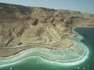 The Dead Sea shoreline. White areas represent former shorelines of the recent past. Further up on the mountain side you can see ancient shorelines from when the lake was much higher.